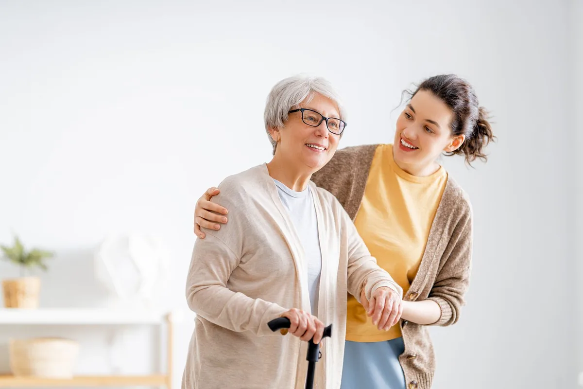 Visiting Care caregiver assisting a senior client at home